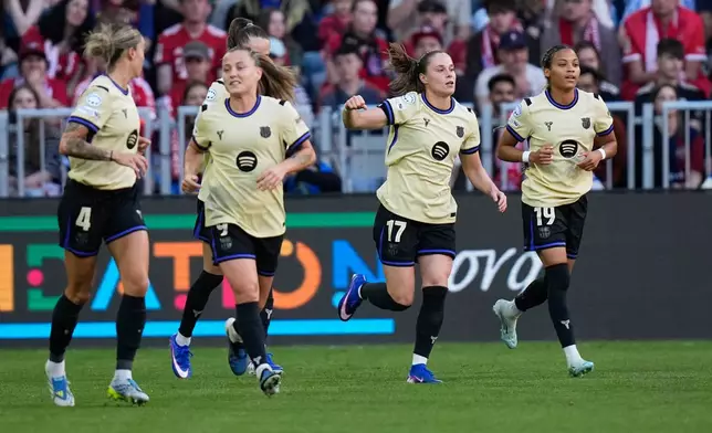 Barcelona's Ewa Pajor, second from right, celebrates after scoring the opening goal during the Women's Champions League semifinal first leg soccer match between Bayern Munich and Barcelona in Munich, Germany, Saturday, April 25, 2026. (AP Photo/Matthias Schrader)