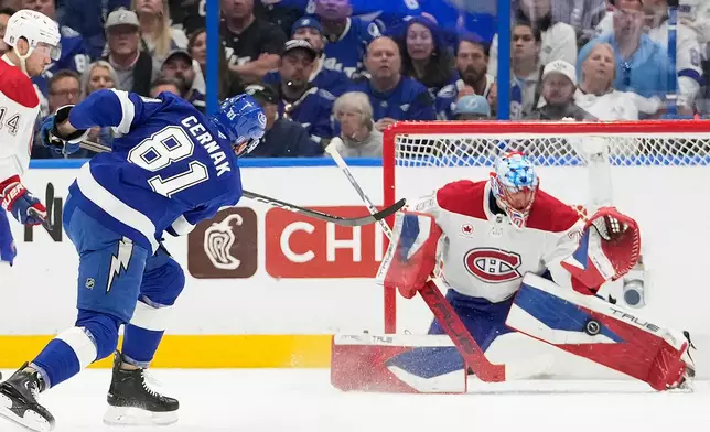 Montréal Canadiens goaltender Jakub Dobes (75) makes a save on a shot by Tampa Bay Lightning defenseman Erik Cernak (81) during the first period in Game 1 of an NHL hockey Stanley Cup first-round playoff series, Sunday, April 19, 2026, in Tampa, Fla. (AP Photo/Chris O'Meara)
