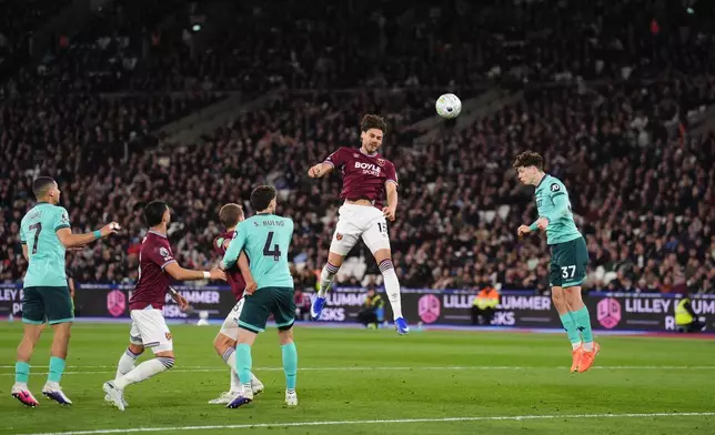 West Ham United's Konstantinos Mavropanos, center, scores their side's first goal of the game during their English Premier League soccer match against Wolverhampton Wanderers in London, Friday, April 10, 2026. (John Walton/PA via AP)