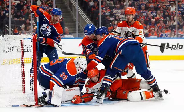 Anaheim Ducks' Troy Terry (19) battles against Edmonton Oilers' goaltender Connor Ingram (39) during the third period of an NHL playoff game in Edmonton on Monday, April 20, 2026. (Codie McLachlan/The Canadian Press via AP)