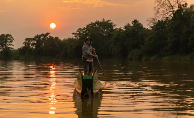 Fisherman Sukjai Yana steers a boat down the Kok River in Chiang Saen, Thailand, Saturday, Feb. 21, 2026. (AP Photo/Anton L. Delgado)
