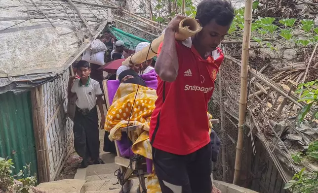 Rahela Begum, a Rohingya survivor, is carried on a bamboo stretcher to a hospital after being rescued on April 9, 2026 from a capsized boat, at a refugee camp in Cox's Bazar, Wednesday, April 15, 2026. (AP Photo/Suzauddin Rubel)