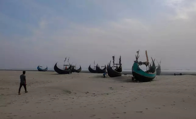 FILE- Fishing boats sit on a beach in Teknaf, Bangladesh, on March 9, 2023. (AP Photo/Mahmud Hossain Opu, File)