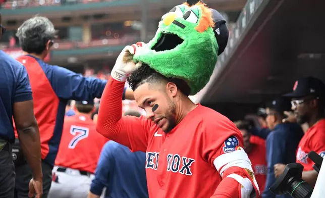 Boston Red Sox's Willson Contreras celebrates in the dugout after hitting a two-run home run in the inning of a baseball game against the St. Louis Cardinals, Sunday, April 12, 2026, in St. Louis. (AP Photo/Michael Thomas)