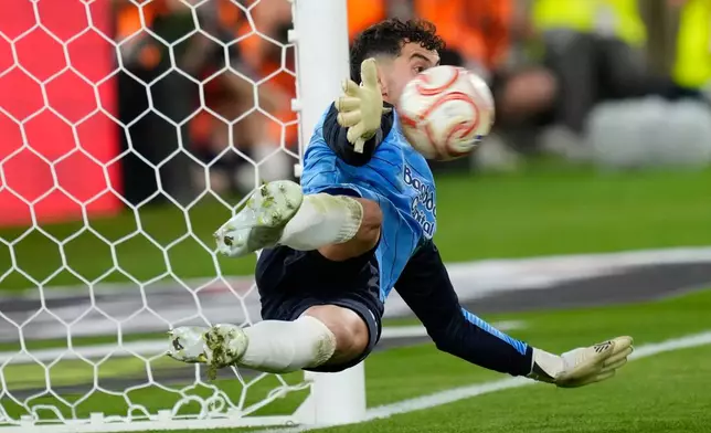 Real Sociedad's goalkeeper Unai Marrero makes a save during during the penalty shoot out at the Copa del Rey final soccer match between Atletico Madrid and Real Sociedad in Seville, Spain, Saturday, April. 18, 2026. (AP Photo/Jose Breton)
