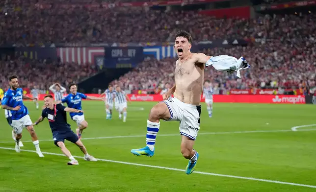 Real Sociedad's Pablo Marin, right, celebrates with teammates as they won the Copa del Rey final soccer match between Atletico Madrid and Real Sociedad in Seville, Spain, Saturday, April. 18, 2026. (AP Photo/Jose Breton)
