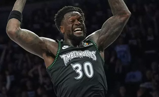 Minnesota Timberwolves forward Julius Randle dunks during the second half of Game 4 of a first-round NBA basketball playoff series against the Denver Nuggets, Saturday, April 25, 2026, in Minneapolis. (AP Photo/Abbie Parr)