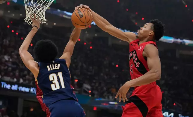 Toronto Raptors forward Scottie Barnes (4) blocks a shot by Cleveland Cavaliers center Jarrett Allen (31) in the second half in Game 2 of a first-round NBA basketball playoffs series in Cleveland, Monday, April 20, 2026. (AP Photo/Sue Ogrocki)