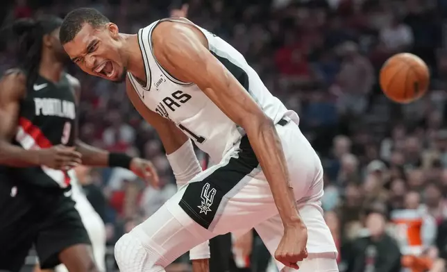 San Antonio Spurs center Victor Wembanyama reacts after a shot during the first half in Game 4 of a first-round NBA basketball playoffs series against the Portland Trail Blazers, in Portland, Ore., Sunday, April 26, 2026. (AP Photo/Jenny Kane)