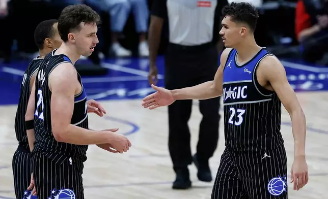 Orlando Magic forward Franz Wagner (22) and forward Tristan da Silva (23) celebrate after a win over the Detroit Pistons in Game 1 of a first-round NBA basketball playoffs series, Sunday, April 19, 2026, in Detroit. (AP Photo/Duane Burleson)
