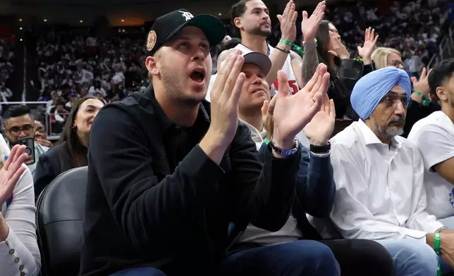 Detroit Lions quarterback Jared Goff cheers on the Detroit Piston during the second half in Game 2 of a first-round NBA basketball playoffs series against the Orlando Magic Wednesday, April 22, 2026, in Detroit. (AP Photo/Duane Burleson)