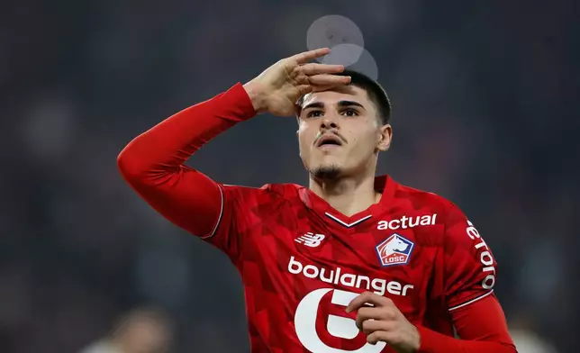 Lille's Matias Fernandez-Pardo celebrates after scoring his side's third goal during the French League One soccer match between Lille and Lens, in Lille, France, Saturday, April 4, 2026. (AP Photo/Jean-Francois Badias)