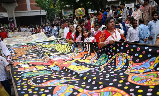People participate at the Baishakhi Shobhajatra procession to celebrate the first day of the Bangla New Year in Dhaka, Bangladesh, Tuesday, April 14, 2026. (AP Photo/Mahmud Hossain Opu)