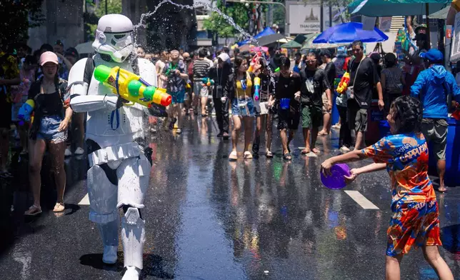 Peoples participate in the Songkran water festival to celebrate the Thai New Year in Bangkok, Thailand, Monday, April 13, 2026. (AP Photo/Arnun Chonmahatrakool)