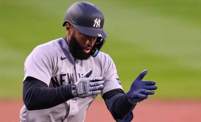 New York Yankees' Amed Rosario celebrates after his three run home run in the first inning off Boston Red Sox pitcher Ranger Suarez during a baseball game at Fenway Park, Wednesday, April 22, 2026, in Boston. (AP Photo/Charles Krupa)