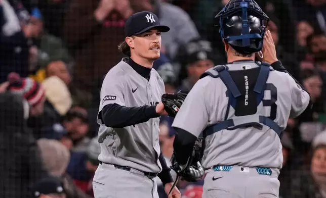 New York Yankees pitcher Max Fried, left, congratulates catcher Austin Wells after completing the sixth inning of a baseball game against the Boston Red Sox at Fenway Park, Wednesday, April 22, 2026, in Boston. (AP Photo/Charles Krupa)