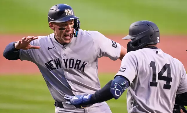 New York Yankees' Amed Rosario (14) is congratulated by Aaron Judge after Rosario's three run home run in the first inning off Boston Red Sox pitcher Ranger Suarez during a baseball game at Fenway Park, Wednesday, April 22, 2026, in Boston. (AP Photo/Charles Krupa)