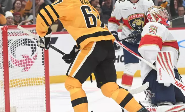 Pittsburgh Penguins right wing Rickard Rakell (67) scores on Florida Panthers goalie Daniil Tarasov (40) during the second period of an NHL hockey game, Sunday, April 5, 2026, in Pittsburgh. (AP Photo/Philip G. Pavely)