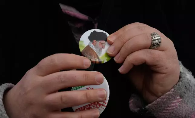 A woman wears a badge with a portrait of the late Iranian Supreme Leader Ayatollah Ali Khamenei, who was killed in the U.S. and Israel strikes on Feb. 28, during a campaign in support of the government at the Enqelab-e-Eslami, or Islamic Revolution, Square in downtown Tehran, Iran, Monday, April 13, 2026. (AP Photo/Vahid Salemi)