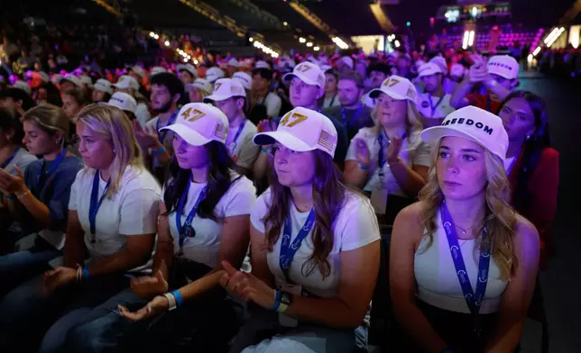 People listen as Vice President JD Vance speaks at a Turning Point USA tour stop at the University of Georgia in Athens, Ga., Tuesday, April 14, 2026. (AP Photo/Erik S. Lesser)