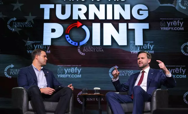 Vice President JD Vance, right, speaks with Turning Point USA spokesperson Andrew Kolvet during a Turning Point USA event at Akins Ford Arena at the Classic Center in Athens, Ga., Tuesday, April 14, 2026. (Chip Somodevilla/Pool via AP)
