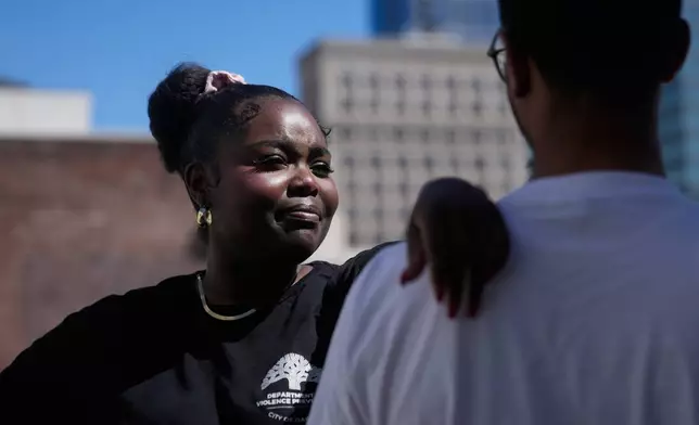Oakland Ceasefire-Lifeline life coach LaSasha Long, left, poses for photos with Bernard C. during an interview Thursday, April 23, 2026, in Oakland, Calif. (AP Photo/Jeff Chiu)