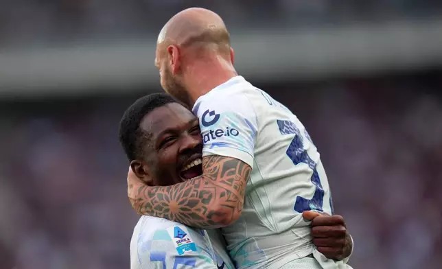 Inter Milan's Marcus Thuram, left, celebrates with teammate Federico Dimarco after scoring his side's opening goal during a Serie A soccer match between Torino and Inter Milan, in Turin, Italy, Sunday, April 26, 2026. (Spada/LaPresse via AP)