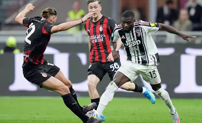 AC Milan's Adrien Rabiot, left, and Juventus' Jeremie Boga vie for the ball during a Serie A soccer match between AC Milan and Juventus, in Milan, Italy, Sunday, April 26, 2026. (Spada/LaPresse via AP)