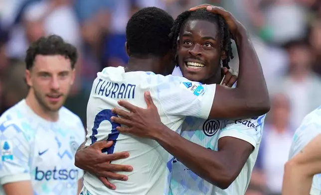 Inter Milan's Yann Aurel Bisseck, right, celebrates with teammate Marcus Thuram after scoring their sides's second goal ball during a Serie A soccer match between Torino and Inter Milan, in Turin, Italy, Sunday, April 26, 2026. (Spada/LaPresse via AP)