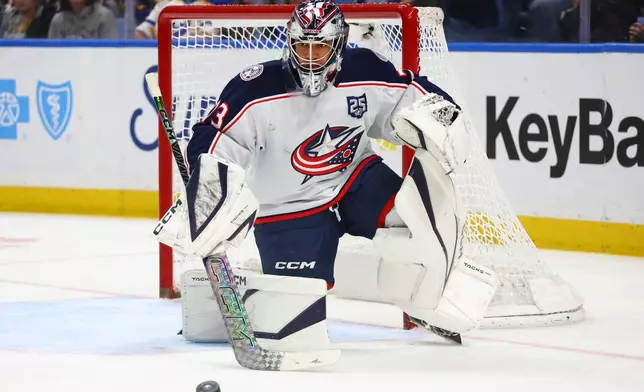 Columbus Blue Jackets goaltender Jet Greaves (73) makes a save during the first period of an NHL hockey game against the Buffalo Sabres Thursday, April 9, 2026, in Buffalo, N.Y. (AP Photo/Jeffrey T. Barnes)