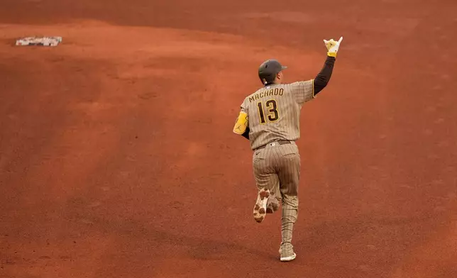San Diego Padres third baseman Manny Machado gestures while rounding the bases after hitting a three-run home run in the fifth inning of a baseball game against the Boston Red Sox, Sunday, April 5, 2026, in Boston. (AP Photo/Robert F. Bukaty)