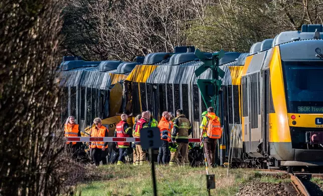 Rescuers at the site where two trains have collided between Hilleroed and Kagerup, north of Copenhagen, Thursday, April 23, 2026. (Steven Knap/Ritzau Scanpix via AP)