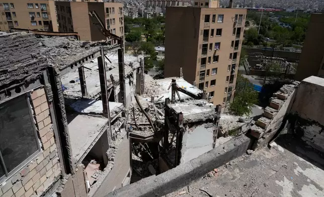 Damage is visible on a residential building that, according to Iranian authorities, was hit by a strike on March 4 during the U.S.-Israeli military campaign, in southeastern Tehran, Iran, Tuesday, April 14, 2026. (AP Photo/Vahid Salemi)