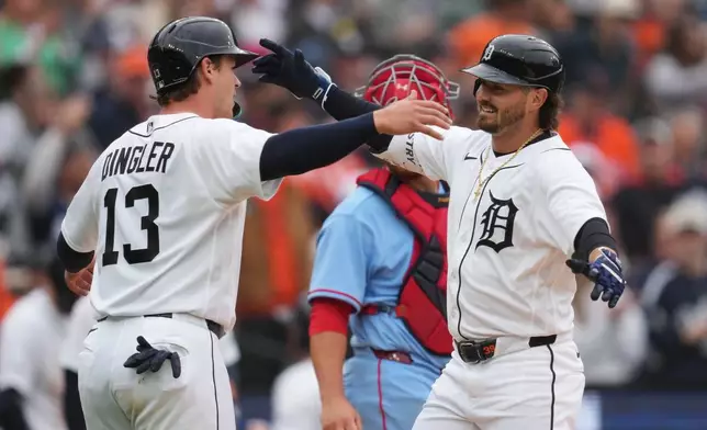 Detroit Tigers' Zach McKinstry, right, celebrates his two-run home run with Dillon Dingler (13) against the St. Louis Cardinals in the fourth inning of a baseball game Saturday, April 4, 2026, in Detroit. (AP Photo/Paul Sancya)