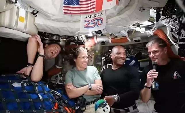 This image from video provided by NASA shows the Artemis II crew, from left, Commander Reid Wiseman, mission specialist Christina Koch, pilot Victor Glover and Canadian astronaut and mission specialist Jeremy Hansen as they answer media questions during a video conference Wednesday, April 8, 2026. (NASA via AP)