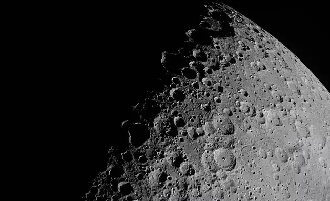 In this image provided by NASA, the Artemis II crew captured this image of a portion of the Moon coming into view along the terminator, the boundary between lunar day and night, during a lunar flyby, Monday, April 6, 2026. (NASA via AP)