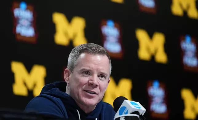 Michigan head coach Dusty May speaks during a news conference ahead of a national semifinal NCAA college basketball tournament game against Arizona at the Final Four, Thursday, April 2, 2026, in Indianapolis. (AP Photo/Abbie Parr)