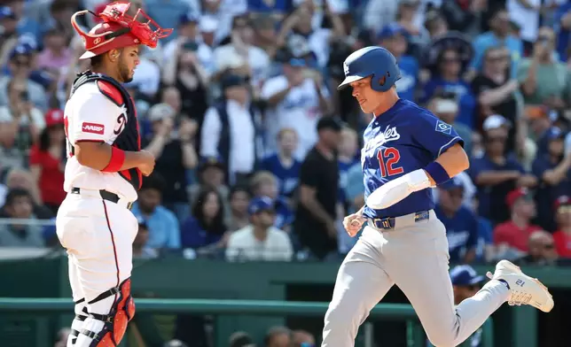 Los Angeles Dodgers' Alex Call (12) scores a run on a sacrifice fly hit by Shohei Ohtani off Washington Nationals pitcher Andre Granillo (not shown) during the ninth inning of a baseball game, Friday, April 3, 2026, in Washington. (AP Photo/Terrance Williams)