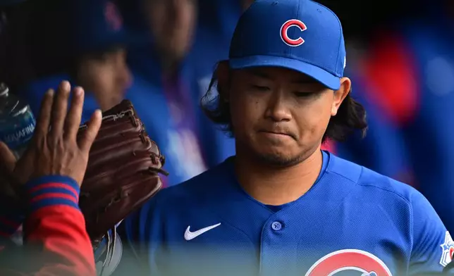 Chicago Cubs starting pitcher Shota Imanaga is congratulated in the dugout after being removed from the game by manager Craig Counsell in the sixth inning in the second baseball game of a doubleheader against the Cleveland Guardians, Sunday, April 5, 2026, in Cleveland. (AP Photo/David Dermer)