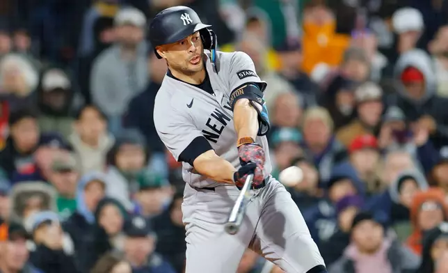 New York Yankees' Giancarlo Stanton hits a two-run double during the sixth inning of a baseball game against the Boston Red Sox, on Tuesday, April 21, 2026, in Boston. (AP Photo/CJ Gunther)