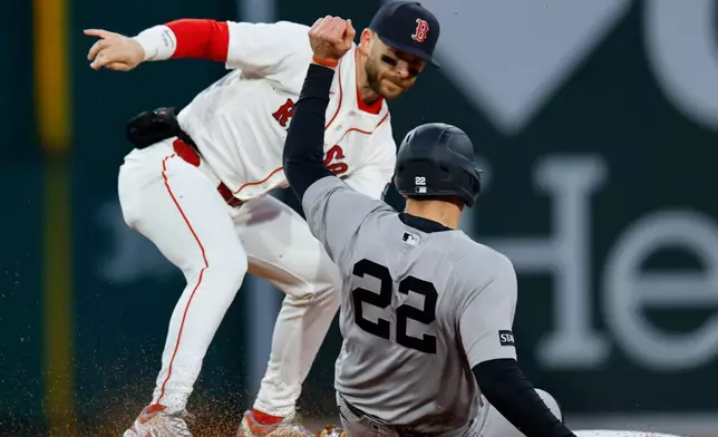 New York Yankees' Ben Rice (22) is tagged out by Boston Red Sox shortstop Trevor Story during the fourth inning of a baseball game, on Tuesday, April 21, 2026, in Boston. (AP Photo/CJ Gunther)