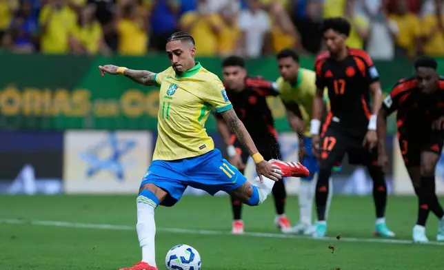 FILE - Brazil's Raphinha scores his side's opening goal against Colombia from the penalty spot during a FIFA World Cup 2026 qualifying soccer match at Mane Garrincha stadium in Brasilia, Brazil, Thursday, March 20, 2025. (AP Photo/Eraldo Peres, File)