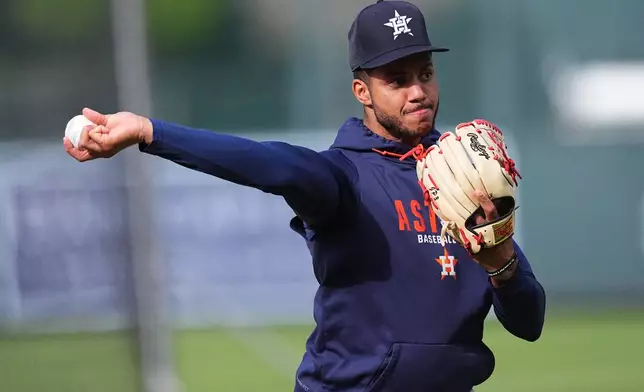 Houston Astros shortstop Jeremy Pena warms up before a baseball game against the Colorado Rockies Tuesday, April 7, 2026, in Denver. (AP Photo/David Zalubowski)