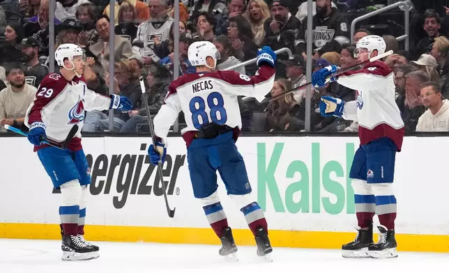 Colorado Avalanche defenseman Cale Makar, right, celebrates his goal with center Nathan MacKinnon, left, and center Martin Necas during the second period of Game 3 in the first round of the NHL hockey Stanley Cup playoffs against the Los Angeles Kings, Thursday, April 23, 2026, in Los Angeles. (AP Photo/Mark J. Terrill)