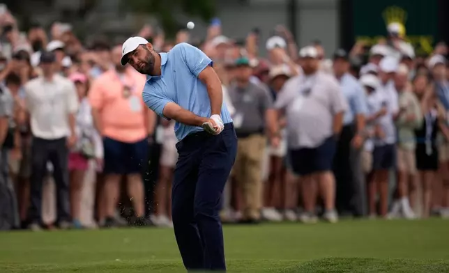 Scottie Scheffler chips onto the 18th green during a playoff in the final round of the RBC Heritage golf tournament Sunday, April 19, 2026, in Hilton Head, S.C. (AP Photo/Mike Stewart)