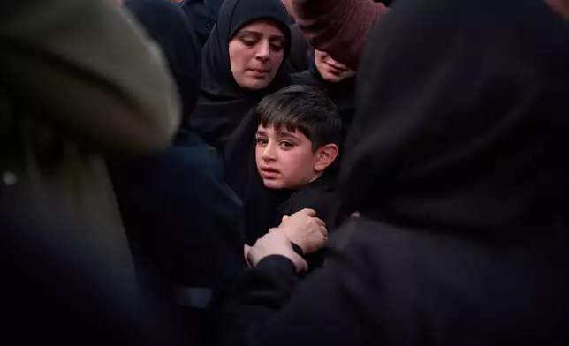 Mohammed, 8, cries next to the coffin of his father, Hussein Makkah, during the funeral of 13 state security officers killed the previous day in an Israeli strike in Lebanon’s coastal city of Sidon, Lebanon, Saturday, April 11, 2026. (AP Photo/Emilio Morenatti)