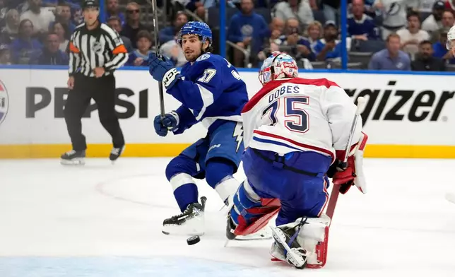 Tampa Bay Lightning center Dominic James (17) watches his shot get past Montréal Canadiens goaltender Jakub Dobes (75) for a goal during the second period in Game 5 of an NHL hockey Stanley Cup first-round playoff series, Wednesday, April 29, 2026, in Tampa, Fla. (AP Photo/Chris O'Meara)