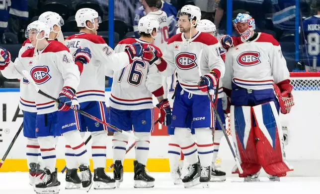 Montréal Canadiens players celebrate their win over the Tampa Bay Lightning in Game 5 of an NHL hockey Stanley Cup first-round playoff series, Wednesday, April 29, 2026, in Tampa, Fla. (AP Photo/Chris O'Meara)