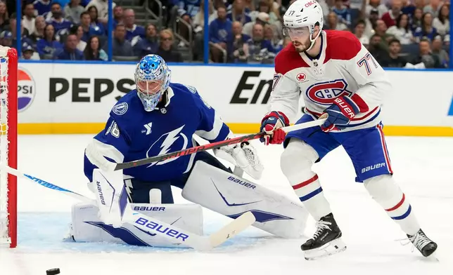 Montréal Canadiens center Kirby Dach (77) plays a loose puck in front of Tampa Bay Lightning goaltender Andrei Vasilevskiy (88) during the first period in Game 5 of an NHL hockey Stanley Cup first-round playoff series, Wednesday, April 29, 2026, in Tampa, Fla. (AP Photo/Chris O'Meara)