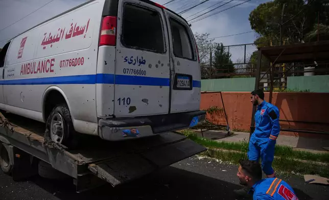 Members of Nabatiyeh Emergency Services inspect the damaged ambulance of their colleague who was killed on a rescue mission by an Israeli airstrike on Wednesday, in Nabatiyeh, southern Lebanon, Friday, April 17, 2026. (AP Photo/Hassan Ammar)
